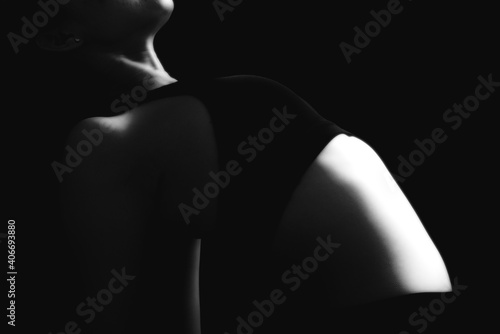 Low key portrait, rimlight portrait woman yoga on black background. © TinPong