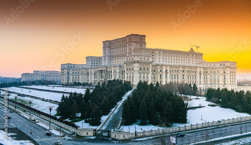 Palace of the Parliament building in Bucharest during an amazing winter sunset landscape landmark of Romania