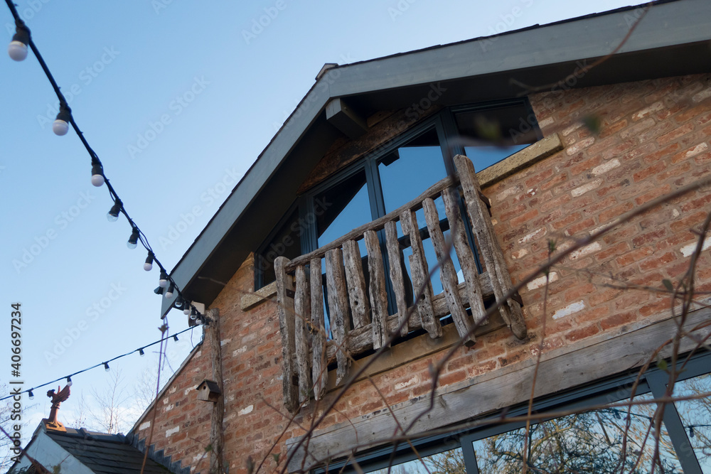 A beautifully modernised old farm barn house, renovated into a modern warm comfy living space. Traditional wood balcony and wooden lintels to blend into the existing traditional scenery. 