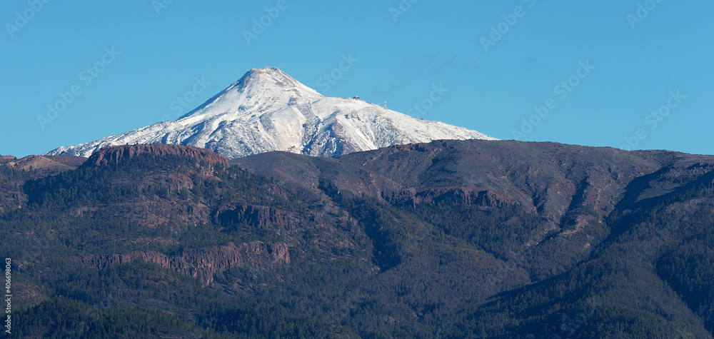 Pico del Teide mountain volcano in snow, bright blue sky. Teide National Park, Tenerife, Canary Islands, Spain. Pico del Teide mountain volcano in snow, bright blue sky. Teide National Park, Tenerife, Canary Islands, Spain.