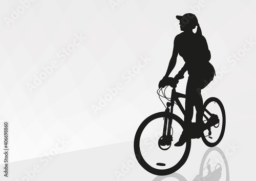 A girl on a bicycle stopped on the road after a long journey