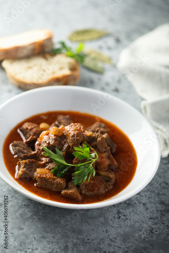 Traditional homemade beef goulash with fresh parsley