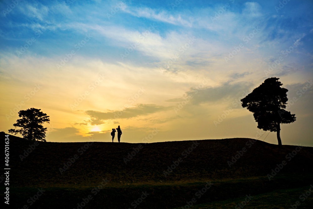 silhouette of a person on a hill
