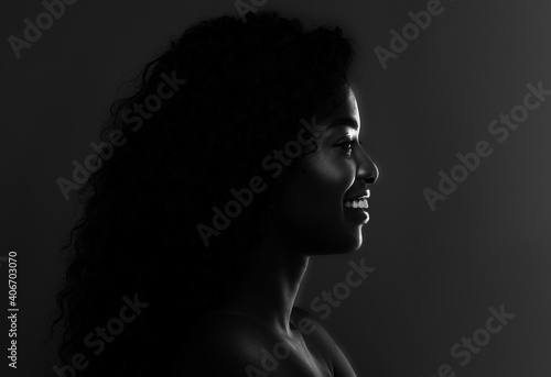 In The Shadow. Profile Of Black Attractive Female Over Dark Background, BW © Prostock-studio