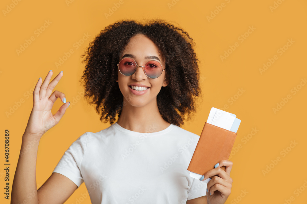 Flight and travel after lockdown covid-19. Happy young mixed race woman in fashion glasses hold passport and ticket Flight and travel after lockdown covid-19. Happy young mixed race woman in fashion glasses hold passport and ticket