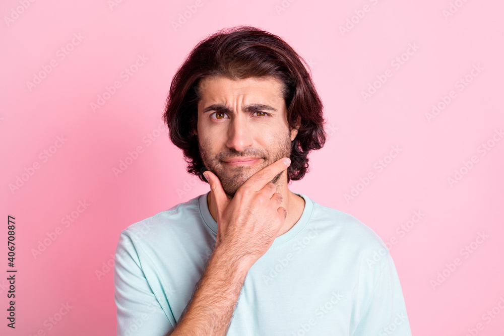 Portrait of intelligent handsome person arm on chin thinking dream wear light blue isolated on pink color background Portrait of intelligent handsome person arm on chin thinking dream wear light blue isolated on pink color background