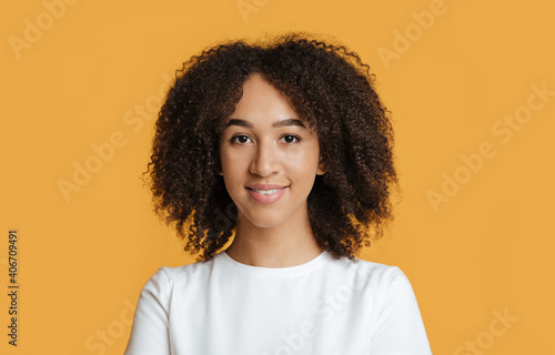 Beautiful cute smile of model. Portrait of smiling millennial african american female looking at camera