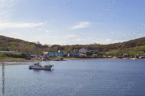 landscape of docked launch and small village on Popovs island © anney_lier