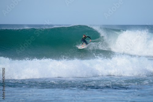 A man surfing a barrel in the ocean