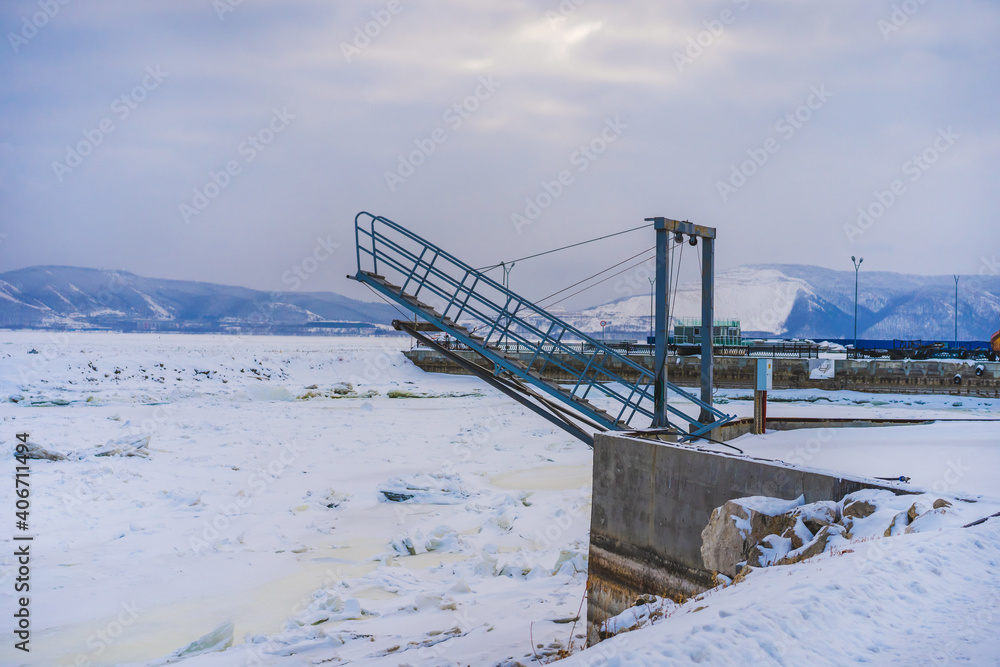 A special ladder for launching yachts and boats into the water. Winter time, frozen river A special ladder for launching yachts and boats into the water. Winter time, frozen river