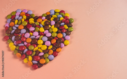  heart created with sweets on pink background