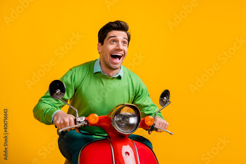 Profile photo of astonished person driving moped hurry open mouth enjoy isolated on yellow color background © deagreez