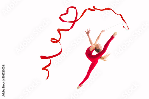 isolated on white background girl gymnast jumping with red ribbon twisting hearts photo