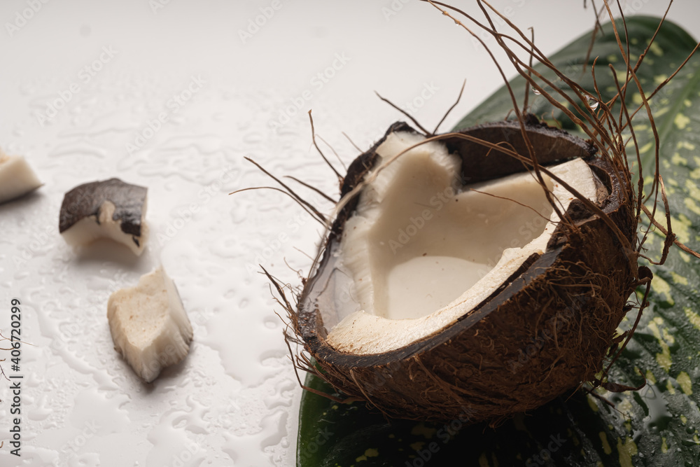 Pieces of chopped coconut close up on white table, close up Pieces of chopped coconut close up on white table, close up