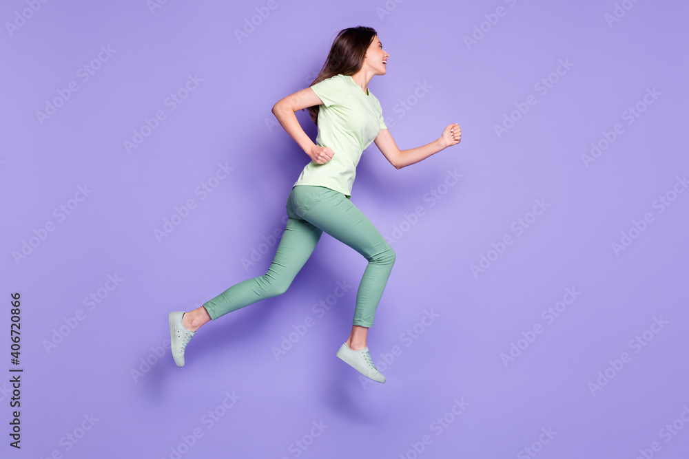 Photo portrait full body view of woman running forward jumping up isolated on vivid violet colored background
