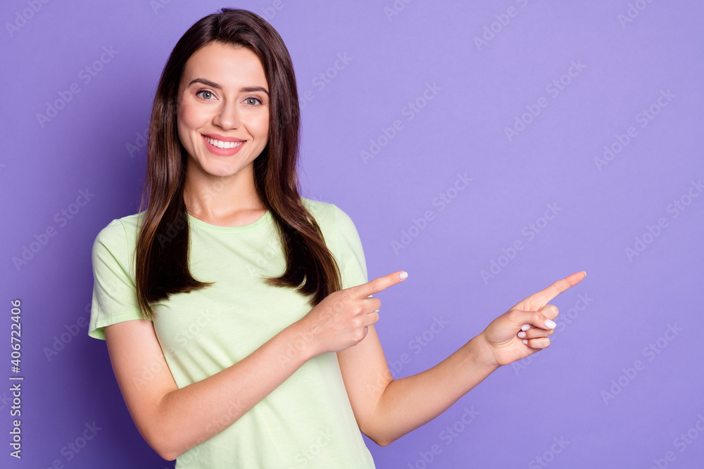 Photo portrait of cheerful happy female student pointing with both hands at empty space isolated on vivid purple color background Photo portrait of cheerful happy female student pointing with both hands at empty space isolated on vivid purple color background