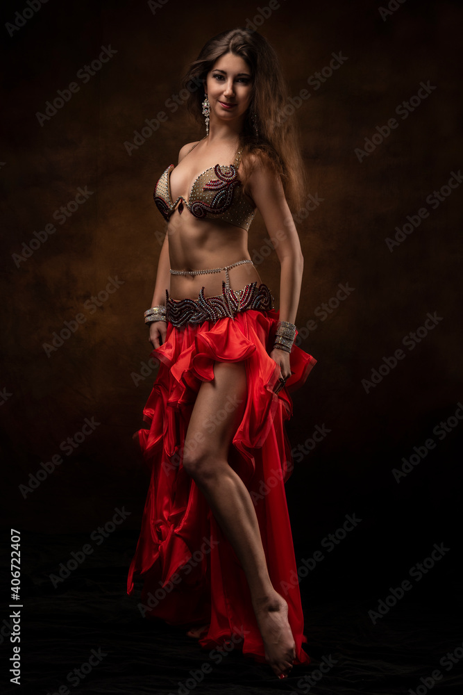 Oriental dancer with a saber. Belly dance. The brunette. Red. Oriental dancer with a saber. Belly dance. The brunette. Red.