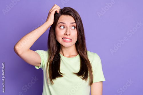 Photo portrait of unsure doubted girl stressed looking at blank space isolated on vibrant purple color background
