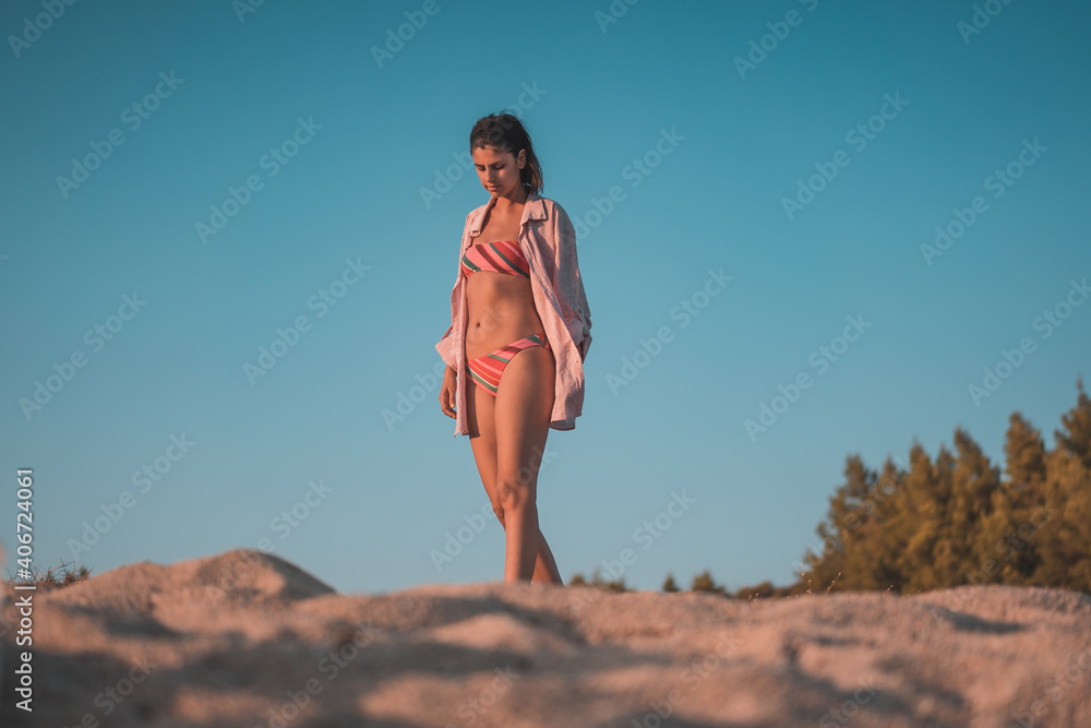 Young beautiful woman having fun at beach. Summer photo of young beautiful girl. Female on beach enjoying sea vacation traveling Young beautiful woman having fun at beach. Summer photo of young beautiful girl. Female on beach enjoying sea vacation traveling
