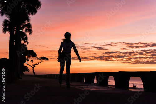 Athletes running on the seashore. Silhouettes of runners at sunrise, fitness concept and lifestyle. © Carlos