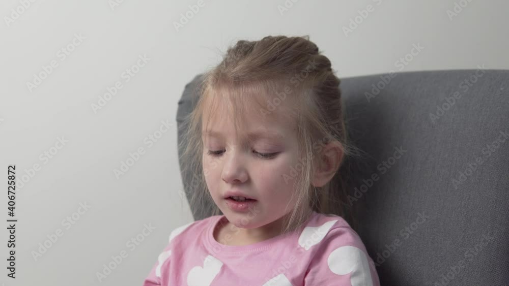 A beautiful little girl removes the baby crown from her head. A beautiful little girl removes the baby crown from her head.