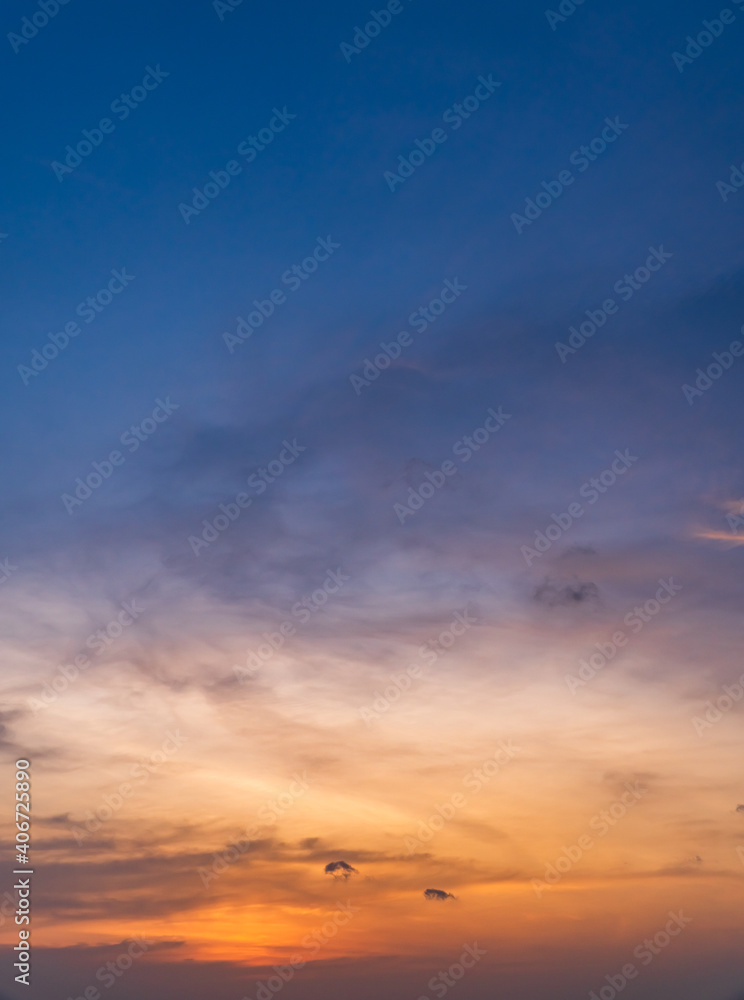 Dusk sky vertical in the evening on twilight with colorful orange sunlight on dark blue sky