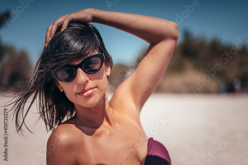Young beautiful woman having fun at beach. Summer photo of young beautiful girl. Female on beach enjoying sea vacation traveling © Vladimir Borovic