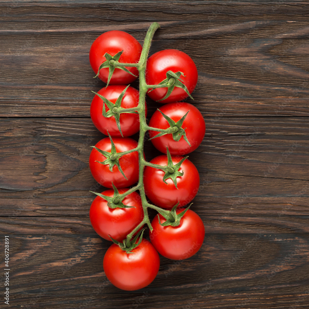 Branch of cherry tomatoes on wooden background, top view Branch of cherry tomatoes on wooden background, top view