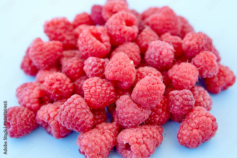 Raspberry pattern, blue background, top view.Pattern of ripe red raspberry on blue background. Vegan food, detox concept Raspberry pattern, blue background, top view.Pattern of ripe red raspberry on blue background. Vegan food, detox concept