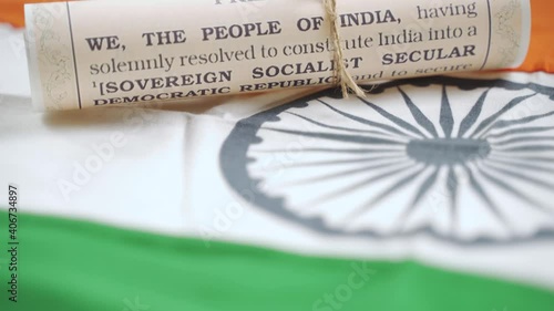 Pan view of Indian constitution or Bharatiya Savidhana preamble with we the people of India writings paper placed on Indian flag - Concept of Freedom, Nationality and patriotism