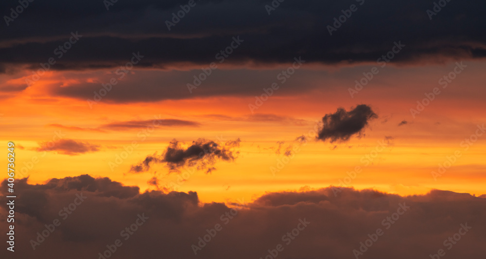 Beautiful dramatic close up clouds on the dark sunset sky. Nature background.