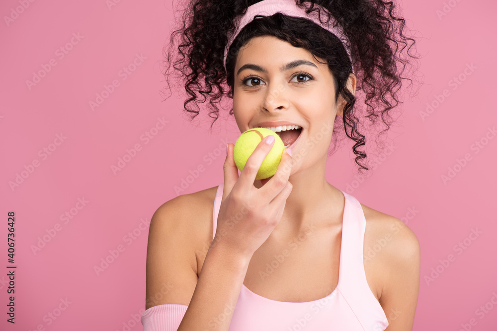 cheerful young woman with open mouth holding tennis ball isolated on pink cheerful young woman with open mouth holding tennis ball isolated on pink