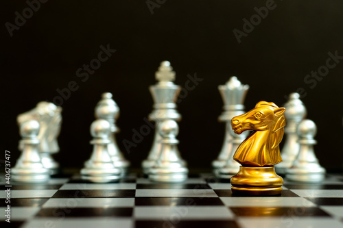 Gold knight in chess game face with the another silver team on black background  Concept for company strategy  business victory or decision 