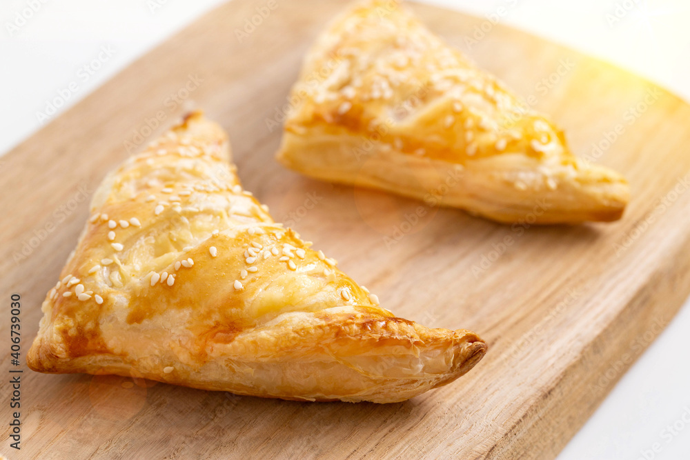 Golden crispy slices with ham and cheese on wooden kitchen board, close-up. Homemade Golden crispy slices with ham and cheese on wooden kitchen board, close-up. Homemade