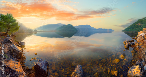 Panorama of mountain lake at sunset © alexlukin