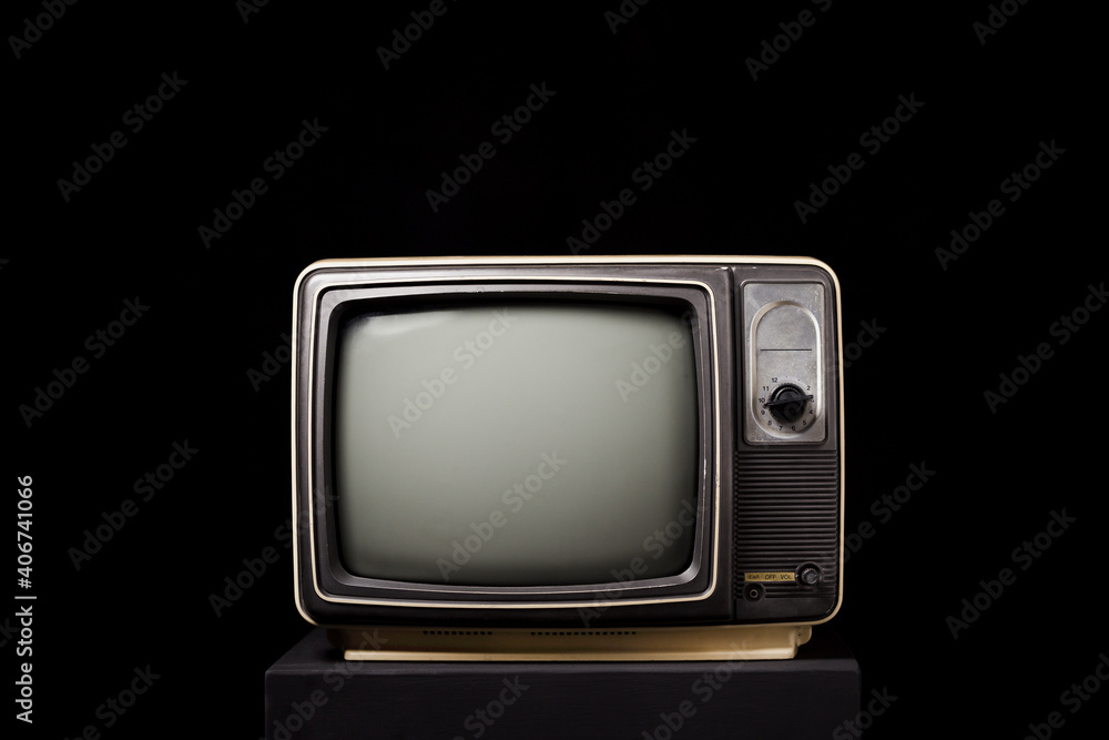Retro old TV on black wooden box on black background
