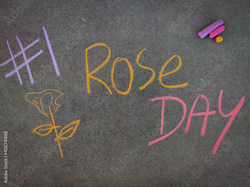 The inscription text on the grey board, #1 Rose day with hand drawn rose . Using color chalk pieces. Valentines week