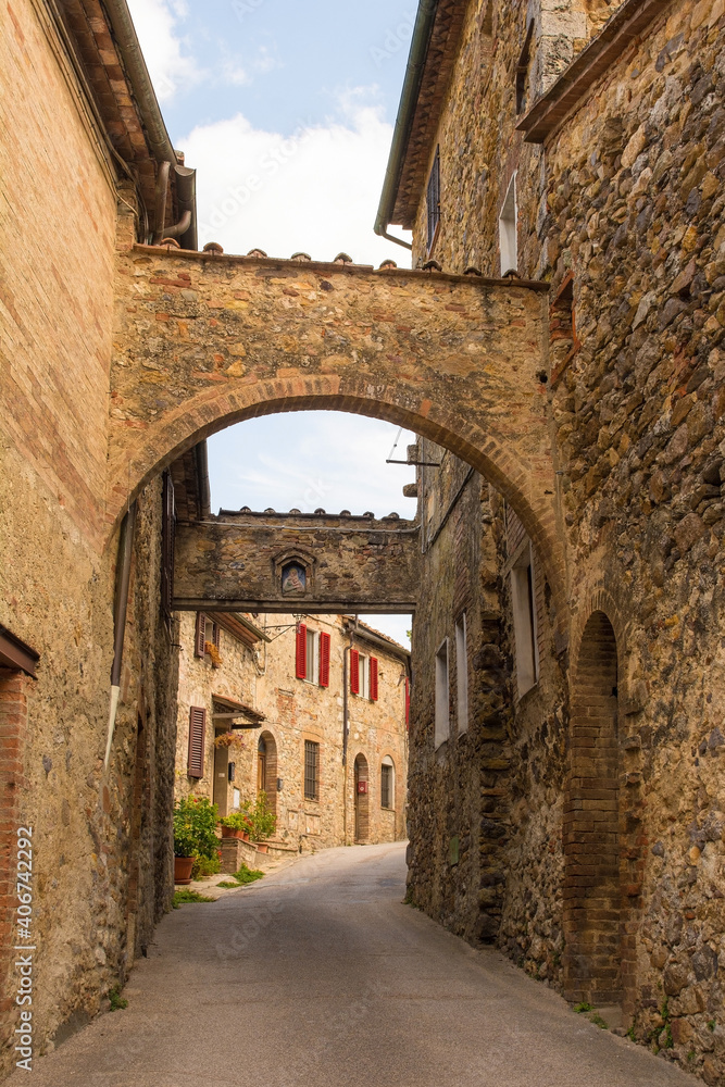 The historic arched entrance to the medieval village of San Lorenzo a Merse near Monticiano in Siena Province, Tuscany, Italy
