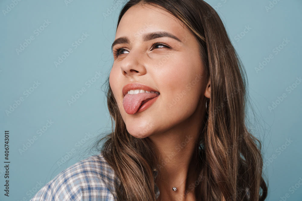 Pleased beautiful girl showing her tongue at camera Pleased beautiful girl showing her tongue at camera