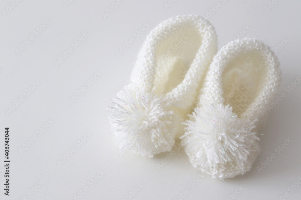 hand knitted white wool baby shoes