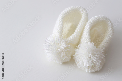 hand knitted white wool baby shoes