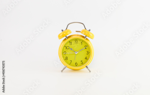 Yellow Alarm Clock With White Background. Selective focus.