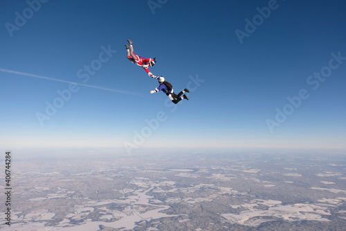 Skydiving. Funny jump. A man and a woman are having fun in the sky.