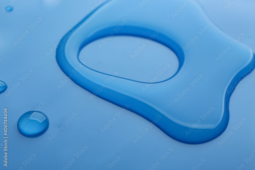Drops of spilled water on blue background, closeup Drops of spilled water on blue background, closeup
