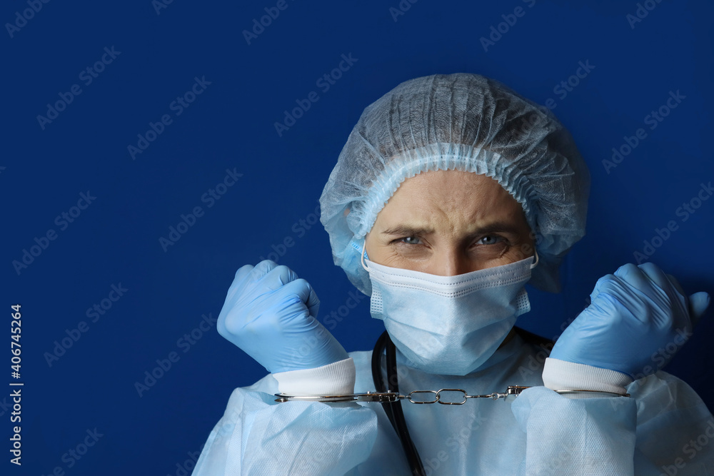 Female doctor in handcuffs upset, concept of medical corruption, bribery Female doctor in handcuffs upset, concept of medical corruption, bribery