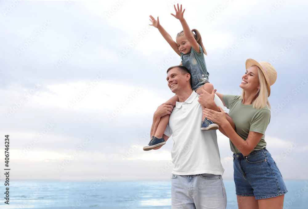 Happy family spending time together near sea on sunny summer day Happy family spending time together near sea on sunny summer day