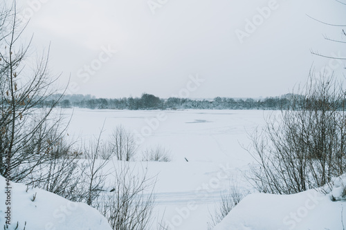 Winter frosty landscape of the river with broken ice