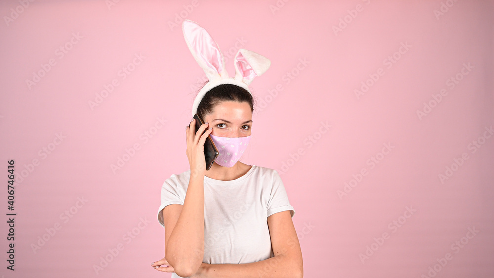 Girl with ears in a mask with a phone
