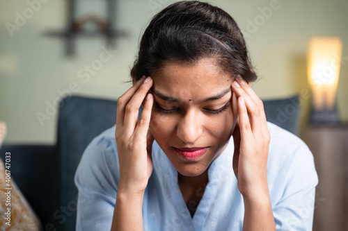 Head shot of young business girl suffering from headache - Concept of stress, work pressure and relationship problems. © WESTOCK