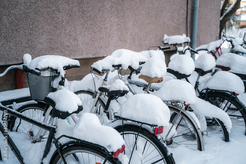 Helsinki, Finland - 01162021: Bicycles in a rack covered by snow